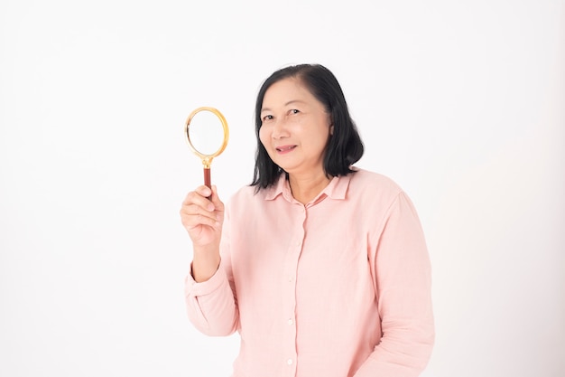 Asian older woman on white wall