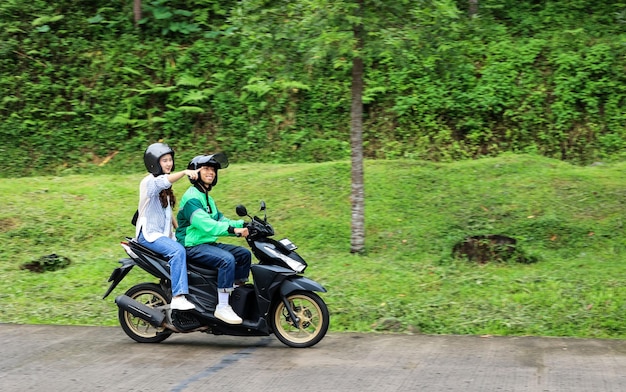 Asian Online Driver with Female Passenger Pointing