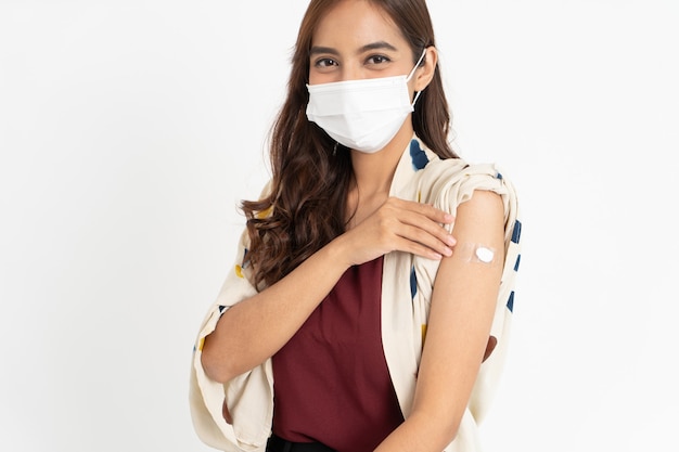 Asian patient getting vaccinated against coronavirus by doctor