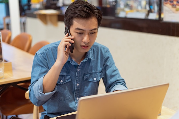 Asian paying man working , in a coffee shop