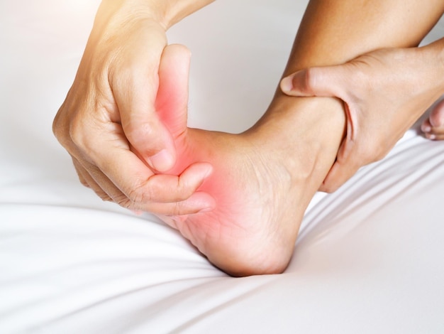 Photo asian people with foot pain and use hands to massage on sole feet to relieve aches