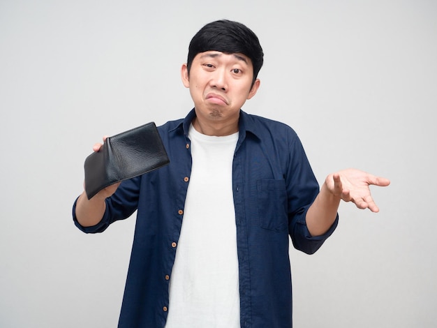 Asian poor man show empty wallet feels bored isolated