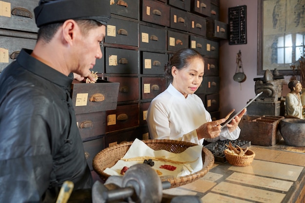 Asian practitioners working in old apothecary