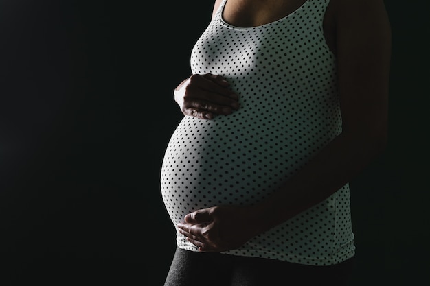 asian pregnant woman touching her belly.