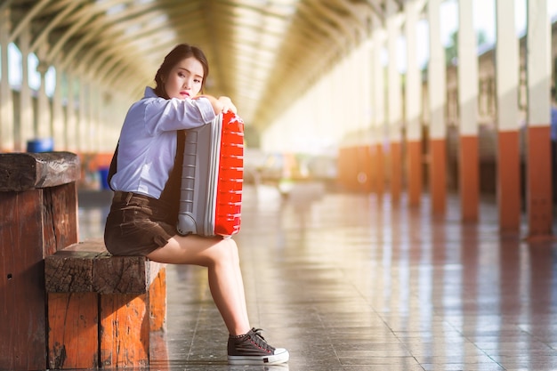 Asian pregnant woman traveler sitting