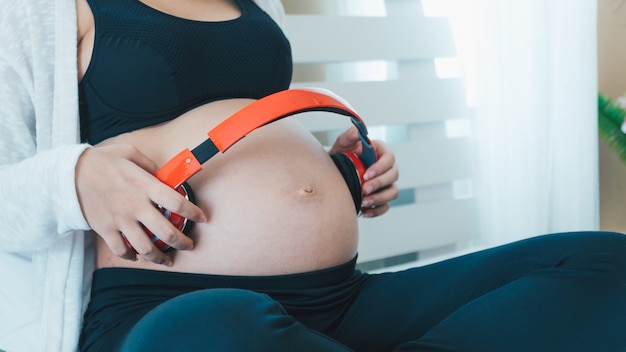 Photo asian pregnant women open the song to the baby in the belly.