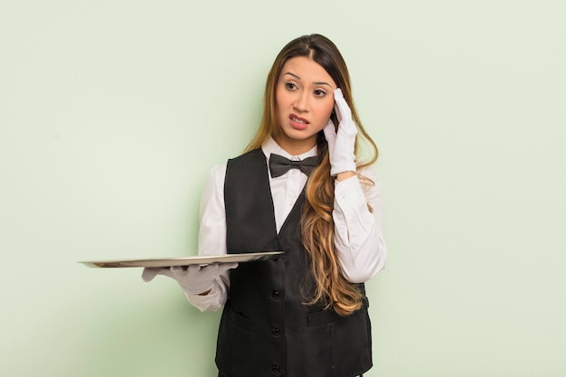 Photo asian pretty woman feeling bored frustrated and sleepy after a tiresome waiter and tray concept