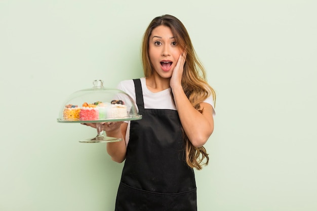 Asian pretty woman feeling shocked and scared home made cakes concept