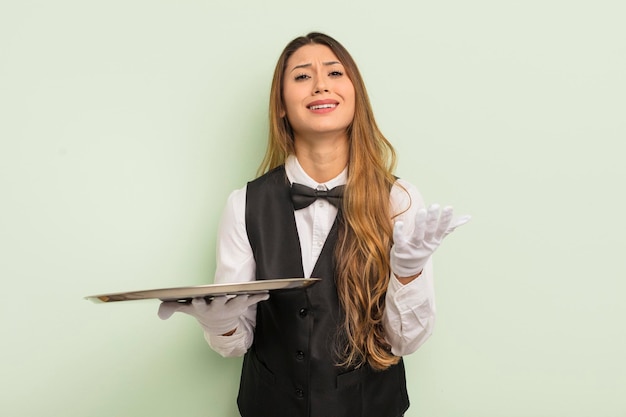 Asian pretty woman looking desperate frustrated and stressed waiter and tray concept