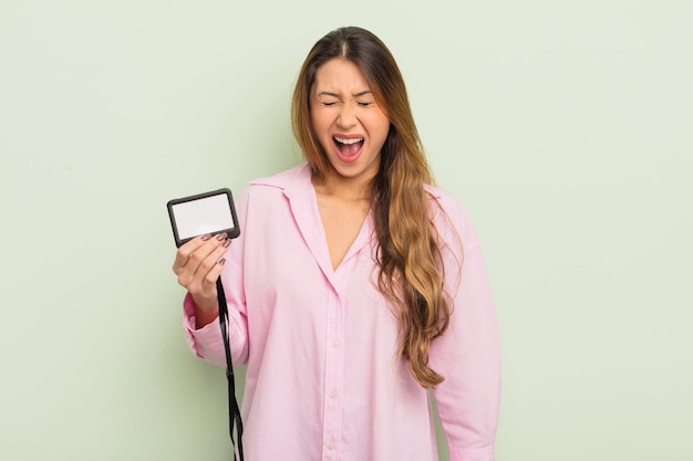 Asian pretty woman shouting aggressively, looking very angry. pass card id concept