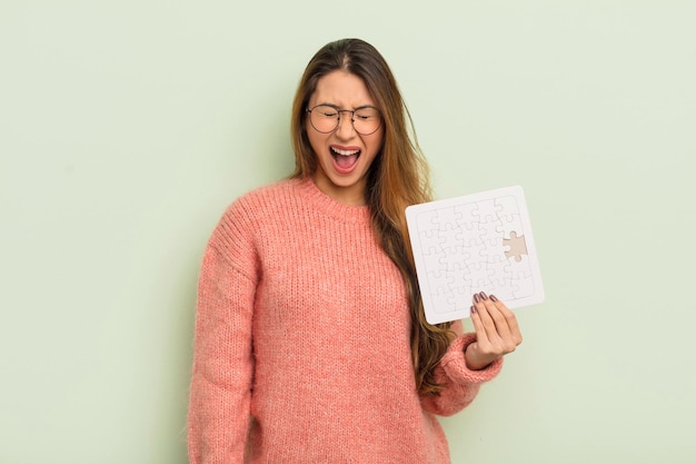 Asian pretty woman shouting aggressively, looking very angry. puzzle concept