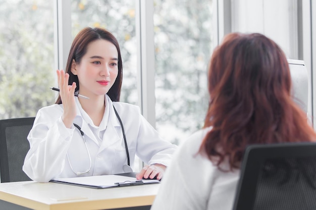 Asian professional woman doctor suggests healthcare solution to her patient elderly examination room