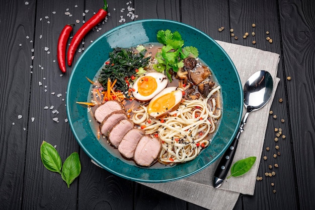 Zuppa asiatica di ramen con funghi tagliatelle fatte in casa di carne e uovo sottaceto