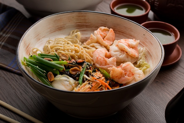 Asian ramen with shrimps and noodles in a restaurant