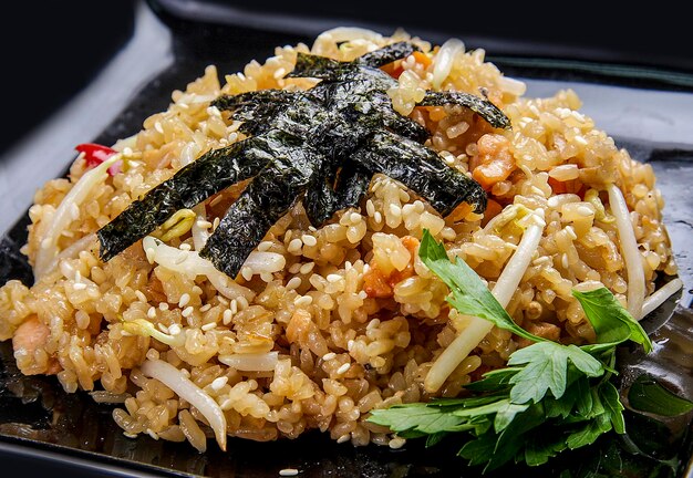 Asian rice with spices on black background