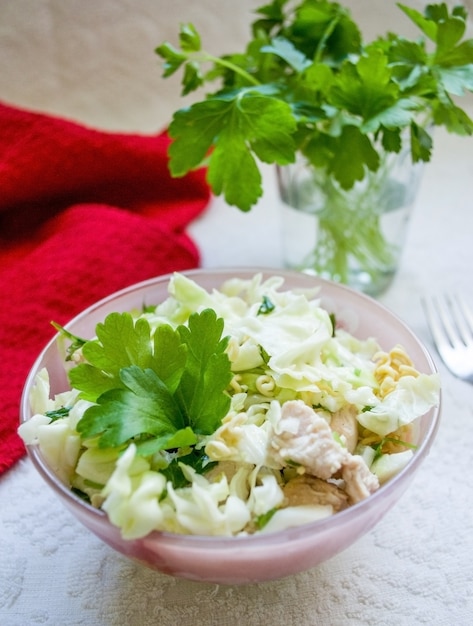 Asian salad with greens and cabbage on light background