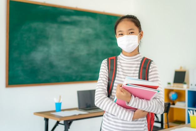 Asian school girl wearing protective mask