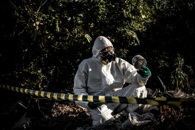 Asian scientist wear Chemical protection suit check danger chemicalworking at dangerous zoneCollecting samples in case of Corona virus investigation outbreaked from China