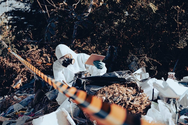 Photo asian scientist wear chemical protection suit check danger chemicalworking at dangerous zonecollecting samples in case of corona virus investigation outbreaked from china