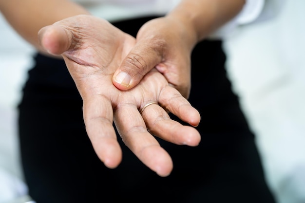 Asian senior or elderly old lady woman patient feel pain her wrist and hand on bed in nursing hospital ward healthy strong medical concept