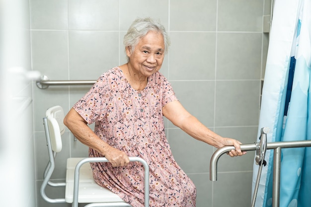 Asian senior or elderly old lady woman patient use toilet bathroom handle security in nursing hospital ward healthy strong medical concept