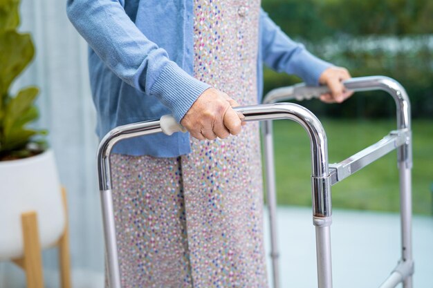 Asian senior or elderly old lady woman patient walk with walker at nursing hospital ward, healthy strong medical concept