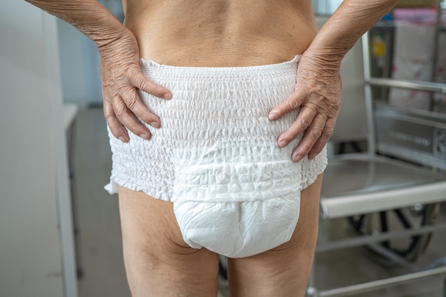 Asian senior or elderly old lady woman patient wearing incontinence diaper in nursing hospital ward, healthy strong medical concept.