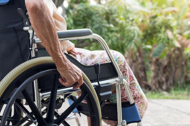 Asian senior or elderly old lady woman patient on wheelchair at the front house