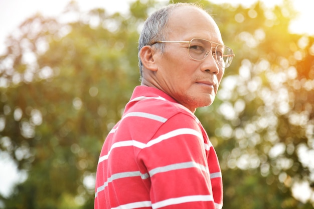 Asian Senior male  smiling at park outdoor.