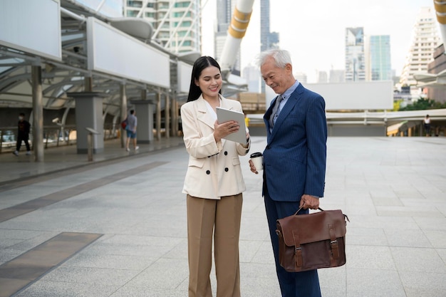 Asian senior mature middle aged businessman and young businesswoman