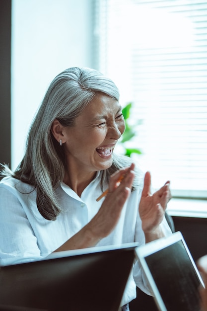 Asian senior woman laughing