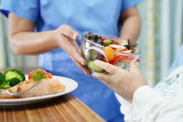 Asian senior woman patient eating breakfast in hospital.