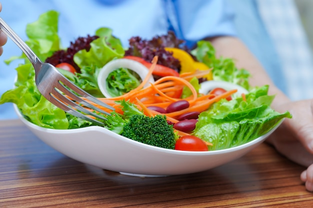 Asian senior woman patient eating breakfast vegetable healthy food.