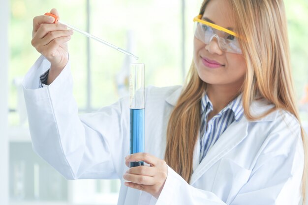 Asian Serious female chemist working in laboratory