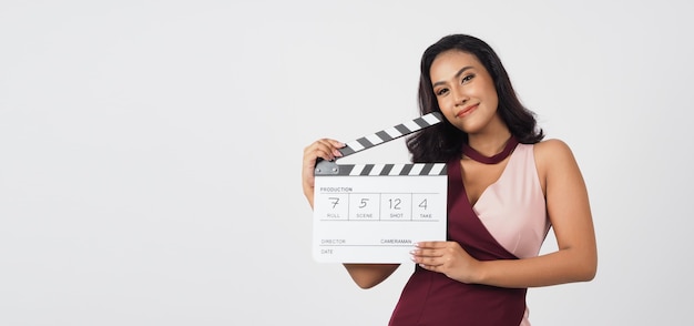 Asian sexy woman hold white clapper board write in number, isolated on white background.She have tan skin ,show film,movies or cinema production concept.