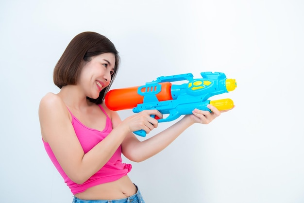 Asian sexy woman with gun water in hand on white backgroundFestival songkran day at thailandThe best of festival of thaiLand of smile