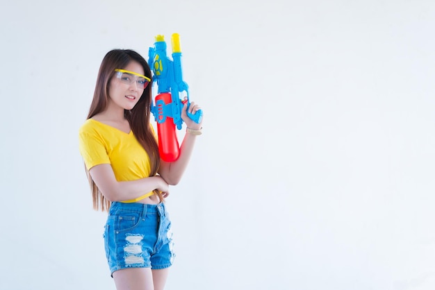 Photo asian sexy woman with water in hand on white backgroundfestival songkran day at thailandthe best of festival of thailand of smile