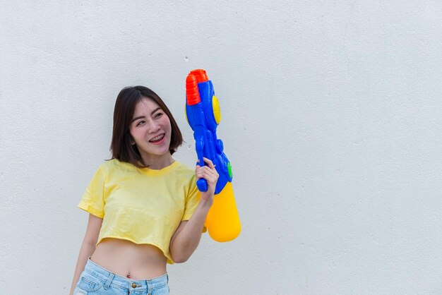 Asian sexy woman with water in hand on white backgroundFestival songkran day at thailandThe best of festival of thaiLand of smile