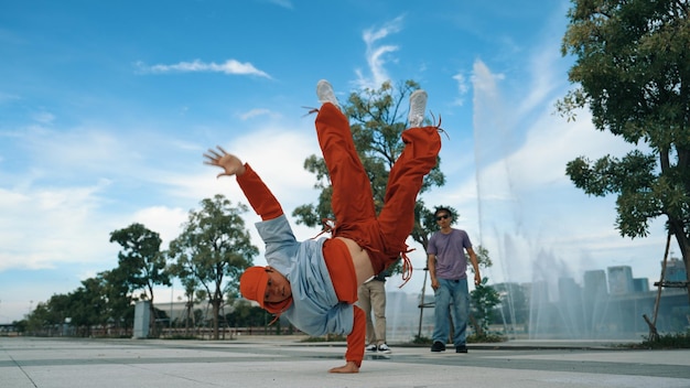 asian skilled hipster doing freeze pose at camera near fountain sprightly