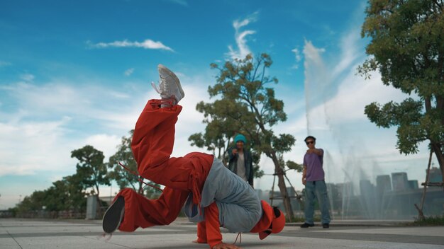 asian skilled hipster doing freeze pose at camera near fountain sprightly