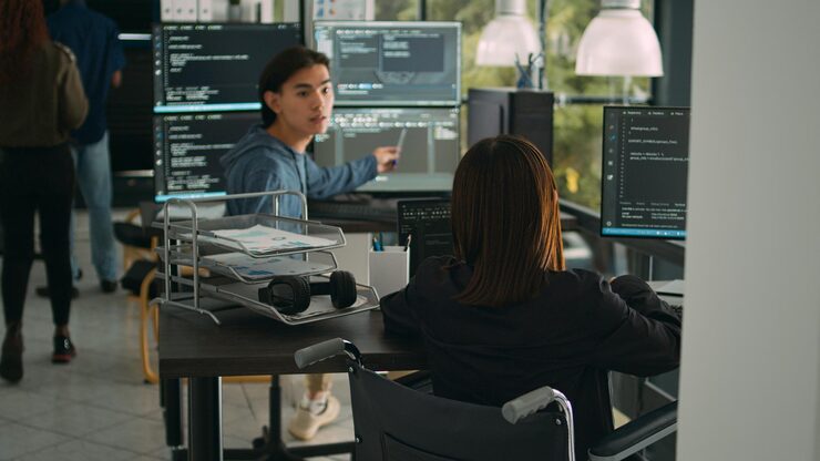 Photo asian software developer with impairment writing code with html script in data room. system engineer programming user interface in artificial intelligence developing agency, disability friendly.