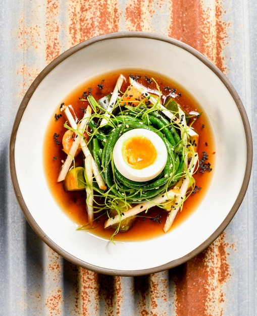 Premium Photo Asian soup above view with hard boiled egg and green beans