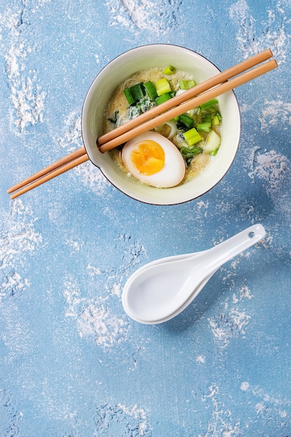 Asian soup with eggs, onion and spinach