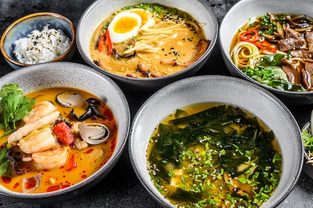 Asian soups in bowls on a black table