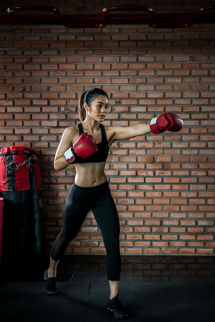 Asian sport woman wear boxing glove in the gymThailand people workoutThe best of fightherStrong woman