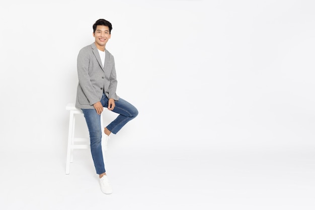 Asian startup businessman standing and smiling in white studio isolated background