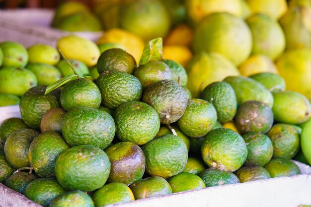 Asian street farmer market selling fresh Green Mandarin in Hoi An, Vietnam. Green colors.