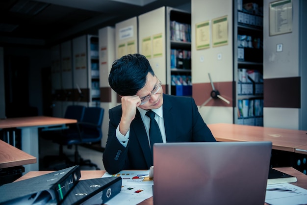 Asian stress business man working failThe owner of the company blamed him with bad wordThai employee serious from hard work from bossSad handsome guy in black suit