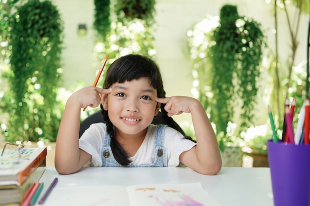 Asian student child girl doing homework at home.