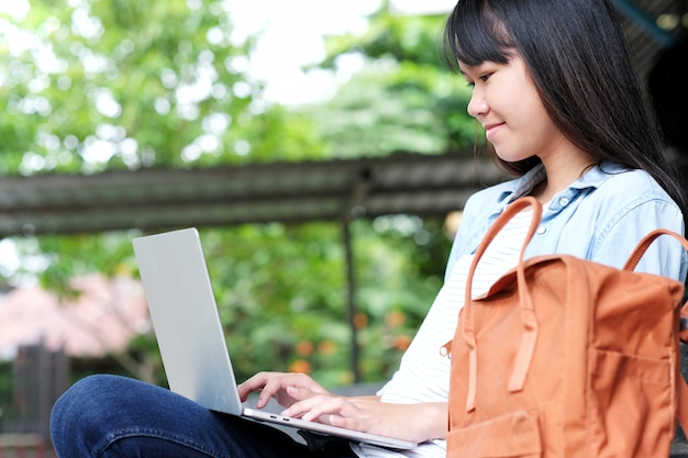 Asian student girl using laptop computer, online education